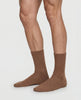 Front view of a women model wearing HA canyon brown wool Socks