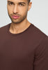 Close-up view of a men model wearing HA glazed chocolate cotton L/SLV Shirt