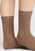 Close-up view of a women model wearing HA canyon brown wool Socks