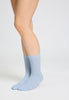 Back view of a women model wearing HA chalky blue wool Socks