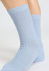 Close-up view of a women model wearing HA chalky blue wool Socks