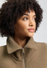 Close-up view of a women model wearing HA suede camel cotton Zippered vest
