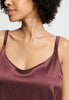 Close-up view of a women model wearing HA apple butter silk Spaghetti Top