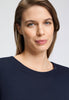 Close-up view of a women model wearing HA deep navy cotton L/SLV Shirt