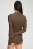 Back view of a women model wearing HA natural teak wool Turtle-Neck Shirt