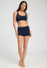 Full-body view of a women model wearing HA deep navy microfibre Crop Top