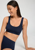 Close-up view of a women model wearing HA deep navy microfibre Crop Top