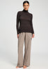 Full-body view of a women model wearing HA dark mocha modal/viscose/tencel Turtle-Neck Shirt