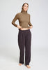 Full-body view of a women model wearing HA suede camel modal/viscose/tencel Turtle-Neck Shirt