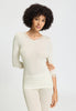 Front view of a women model wearing HA misty white wool 3/4 SLV Shirt