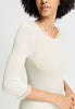 Close-up view of a women model wearing HA misty white wool 3/4 SLV Shirt