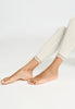 Close-up view of a women model wearing HA misty white wool Leggings