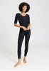 Full-body view of a women model wearing HA black wool S/SLV Shirt