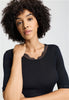 Close-up view of a women model wearing HA black wool S/SLV Shirt